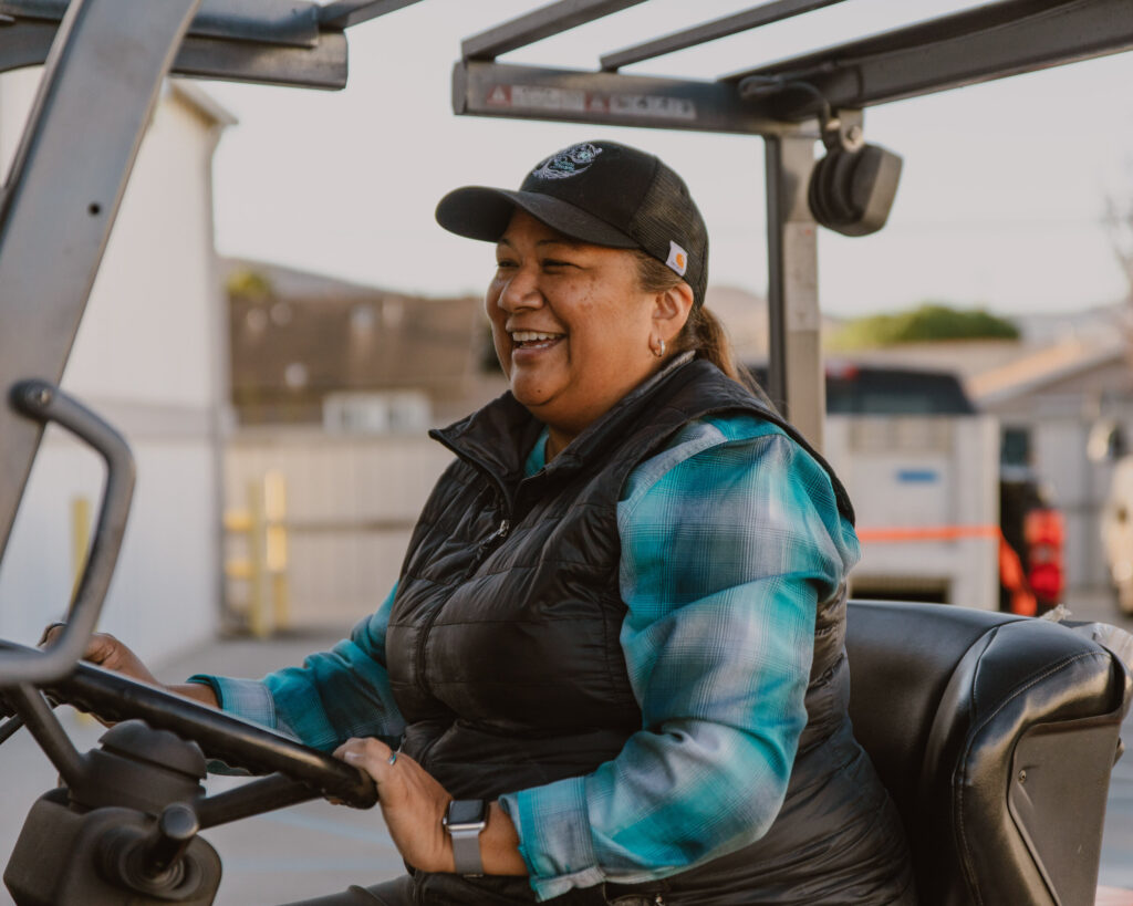 Native american winemaker Tara Gomez on tractor