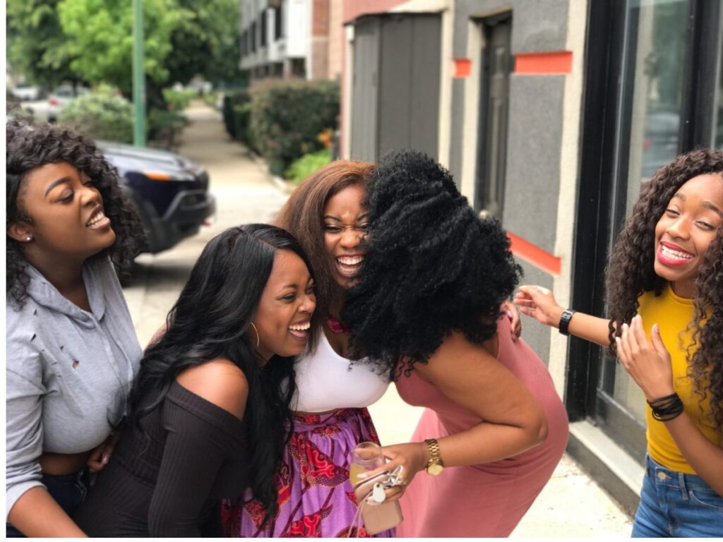 A group of friends laughing together, boosting their parasympathetic nervous system function.