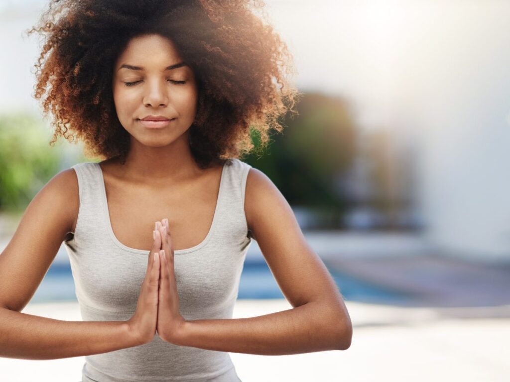 A woman practicing mindfulness meditation to regulate her parasympathetic nervous system.