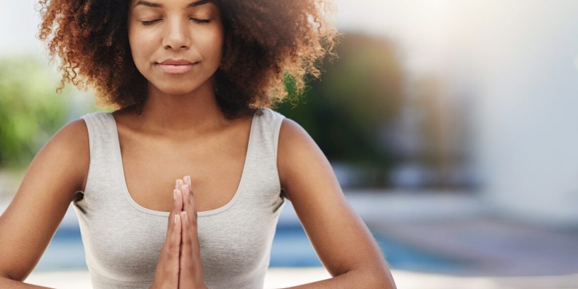 A woman practicing mindfulness meditation to regulate her parasympathetic nervous system.