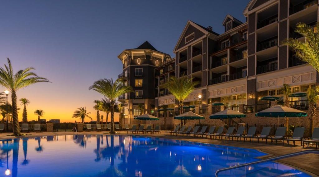 Luxury poolside view at Henderson Beach Resort at sunset.