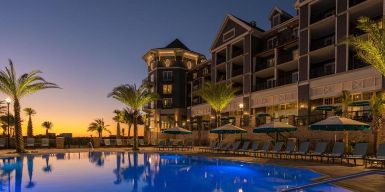 Luxury poolside view at Henderson Beach Resort at sunset.