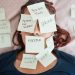 Overwhelmed woman lying on a bed with sticky notes that say "Hustle," "Grind," and "No Sleep," representing burnout from hustle culture.
