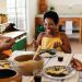 Afro-Brazilian family from the African diaspora enjoying a joyful home-cooked meal together.