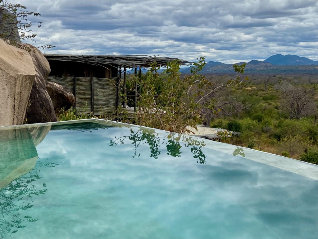 Infinity pool overlooking a bungalow at a luxury safari lodge in Tanzania.